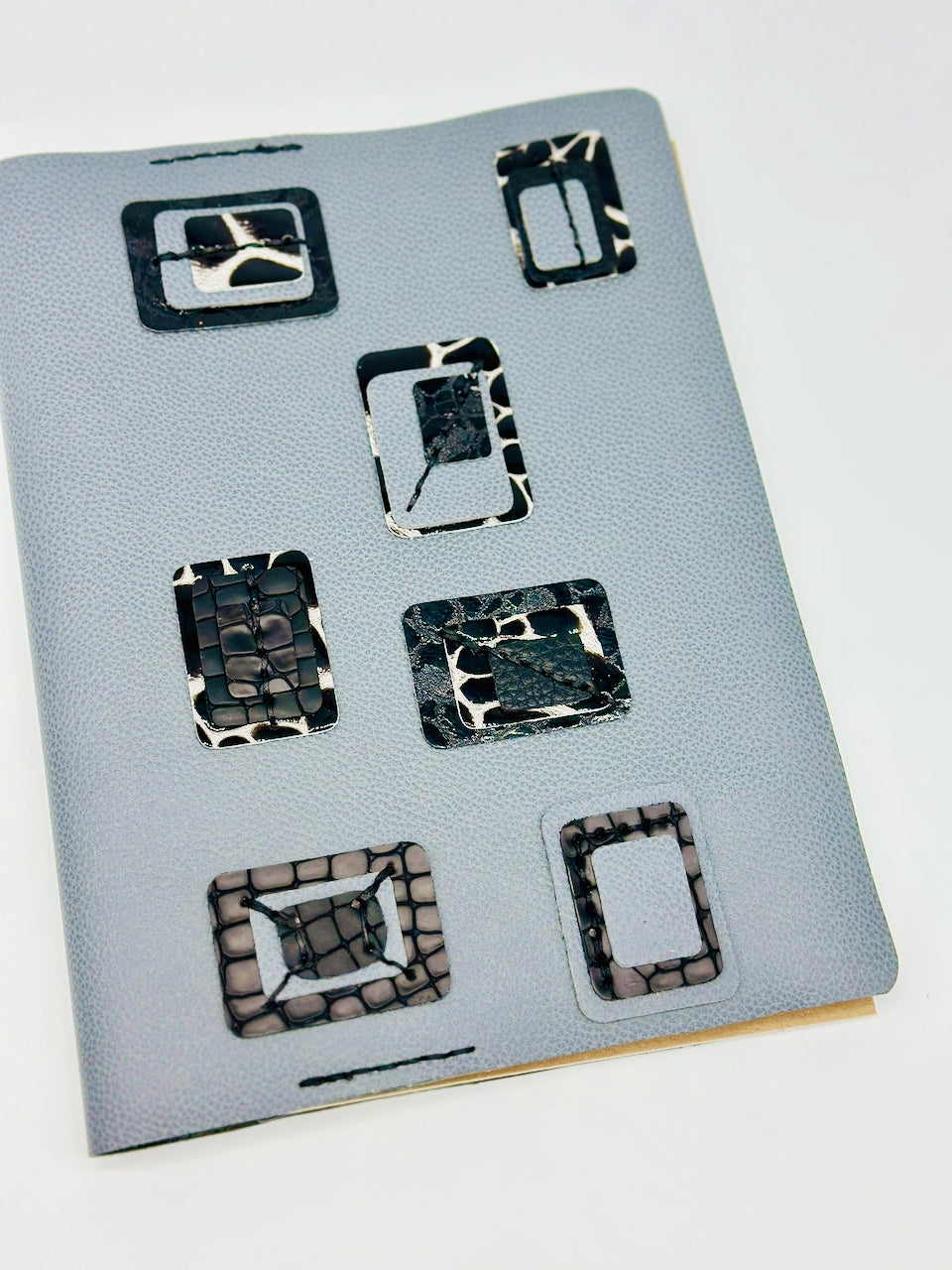 Blue-leather-journal-cover-with-blue-and-black crocodile embossed-squares-high angle