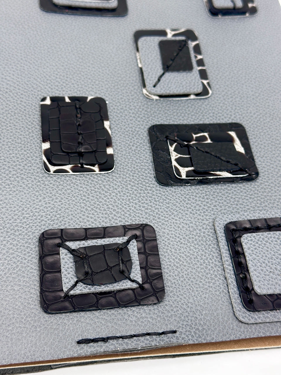 Blue-leather-journal-cover-with-blue-and-black-crocodile embossed squares-close-up-of-squares close up