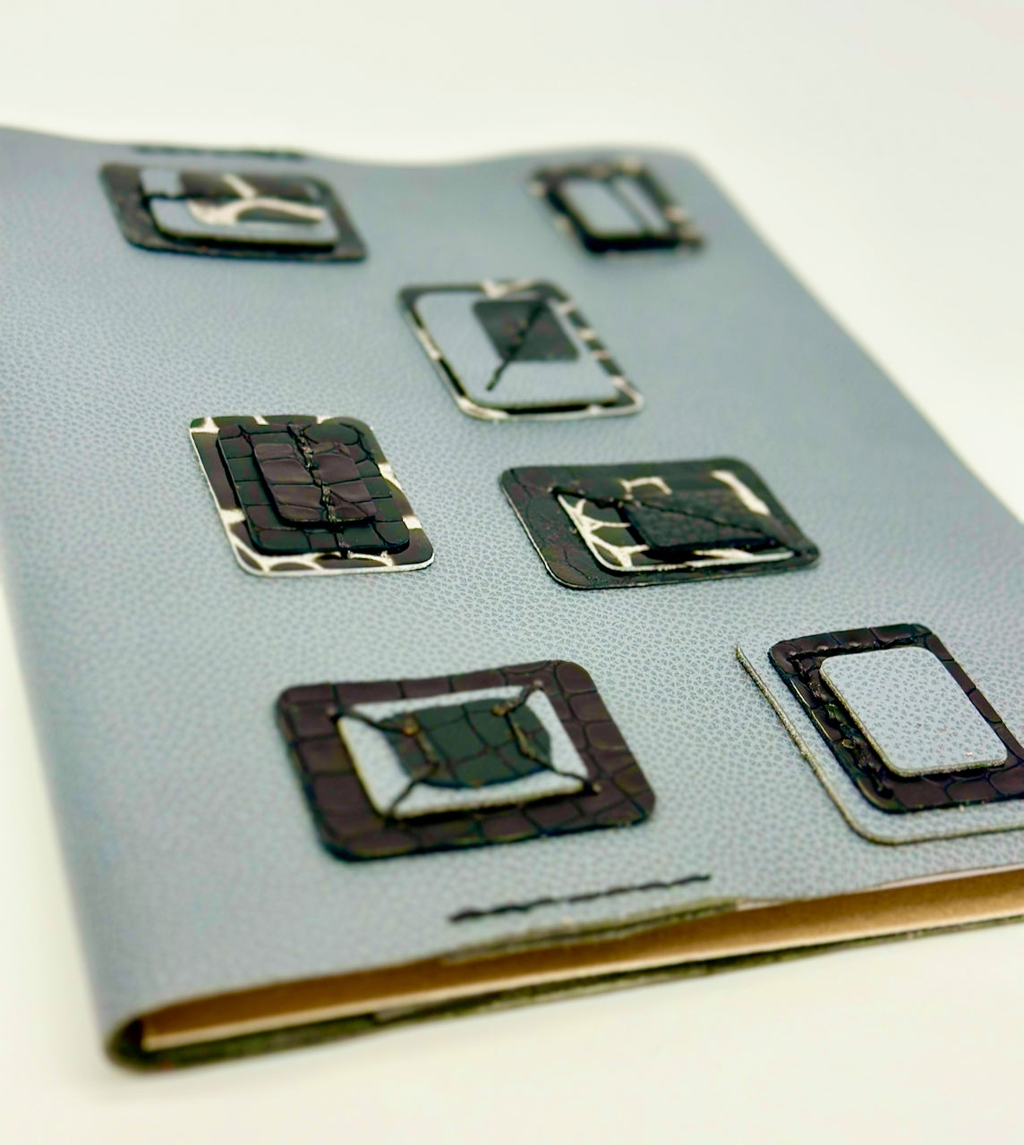 soft focus angled view of blue leather journal