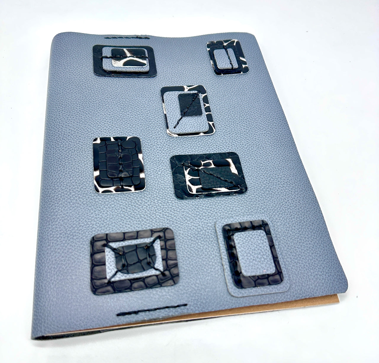 Blue-leather-journal-cover-with-blue-and-black-squares-wide-shot