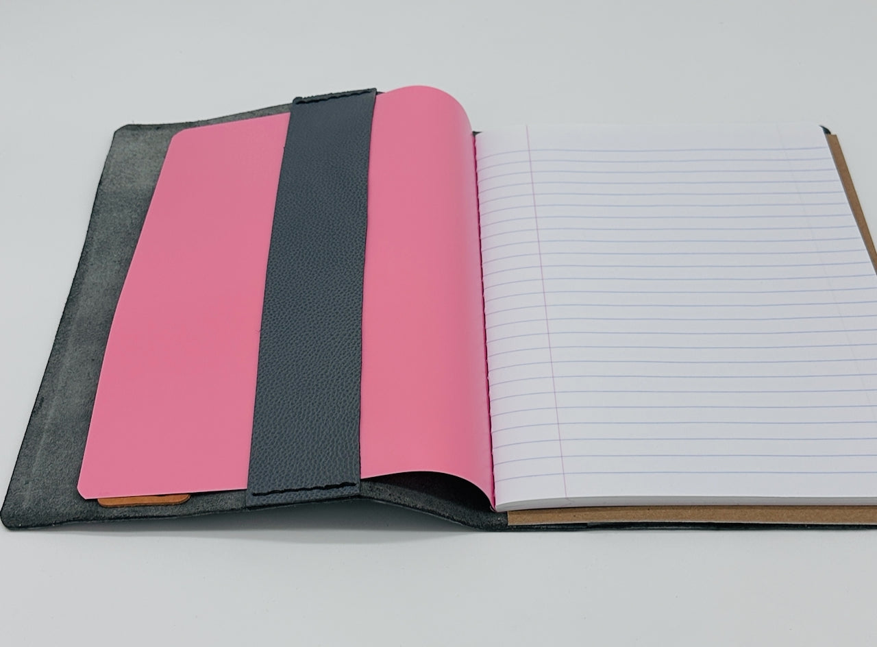 inside flap of the blue and black squared leather journal shows refillable paper insert