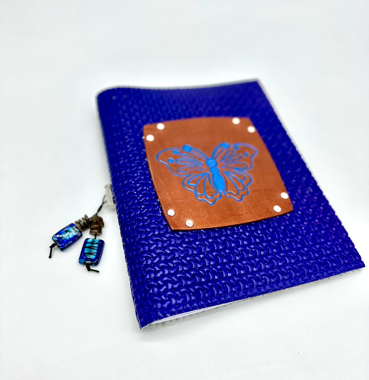 Front cover of blue waffle leather journal handmade by Undercover Popular Leather Goods