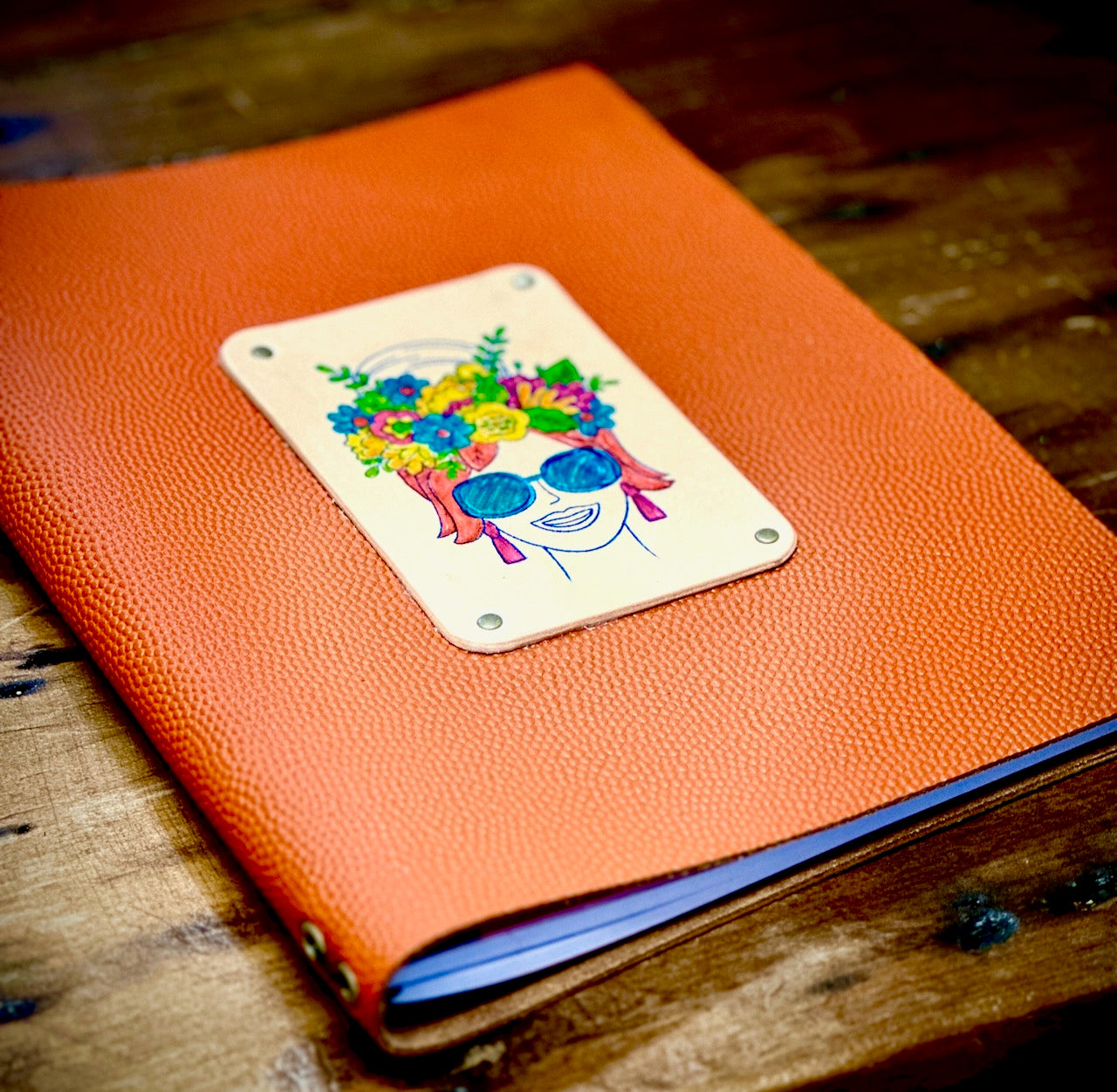 gorgeous photo of an orange pebbled leather handmade refillable journal made by Undercover Popular Leather goods