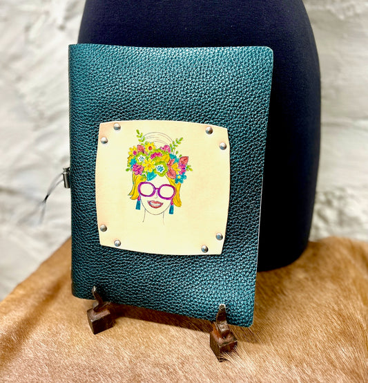 Green metallic leather refillable journal featuring a hand painted woman with sunglasses and flowers in her hair