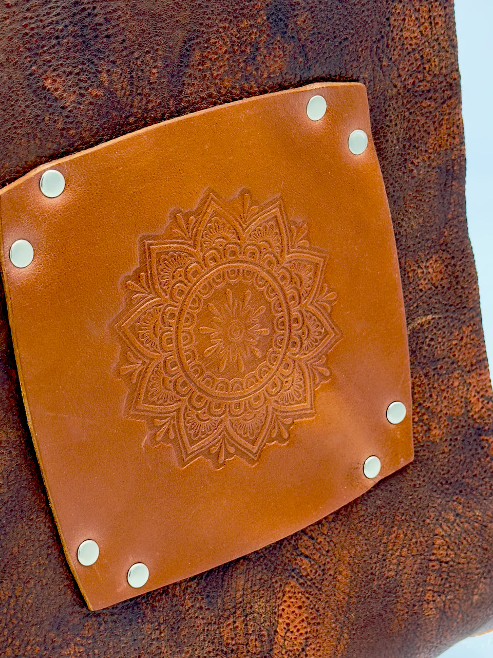 detail of embossed mandala on leather journal