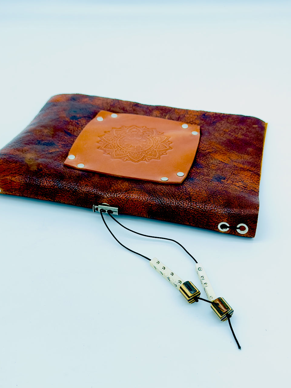 side angle of leather journal with mandala