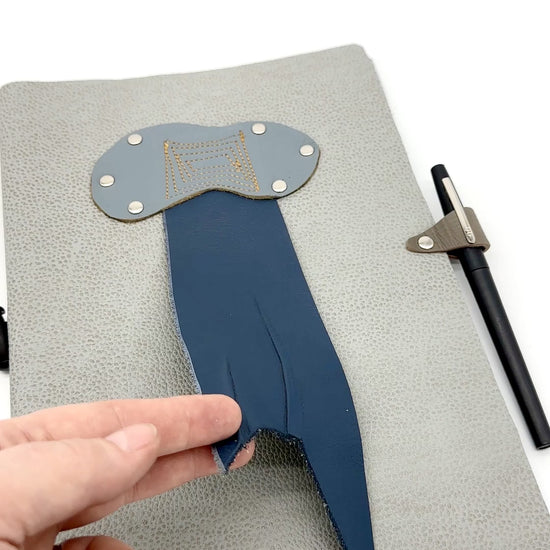 video showing front and back cover of leather journal with rain cloud and thunderbolt